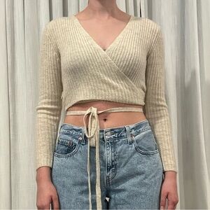 Urban outfitters beige wrap around cropped sweater.